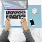 Portable Folding Laptop Desk in blue with height adjustable legs and built-in cup holder, used on bed for working with laptop and phone.