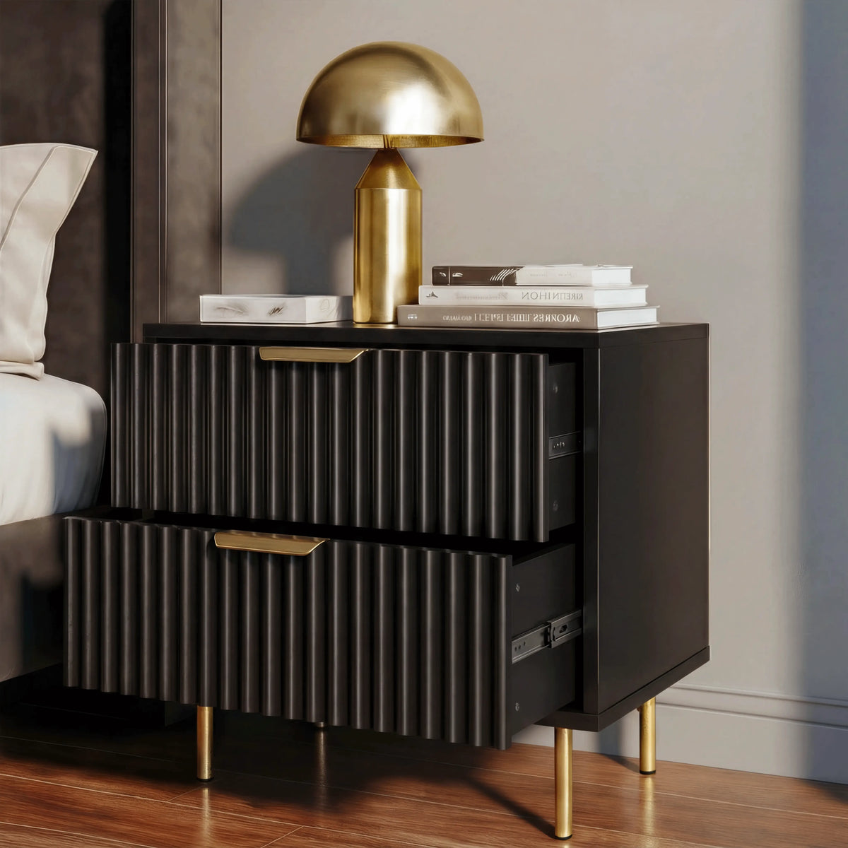 [Black] bedside cabinet unit with two drawers, placed beside a bed with a table lamp on top in a bedroom