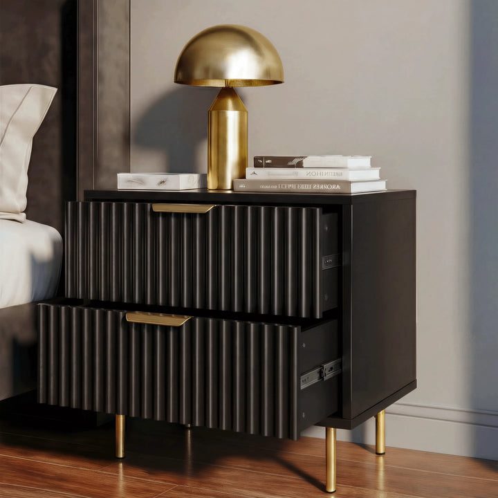 [Black] bedside cabinet unit with two drawers, placed beside a bed with a table lamp on top in a bedroom