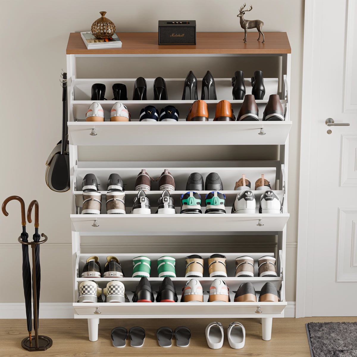 [White] Open shoe cabinet, every tilt door dropped to reveal pairs of shoes held on angled interior racks