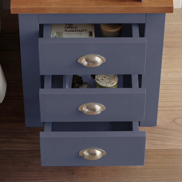 [Blue] Overhead view of blue shaker bedside with all 3 drawers cascade-open, magazine in top drawer