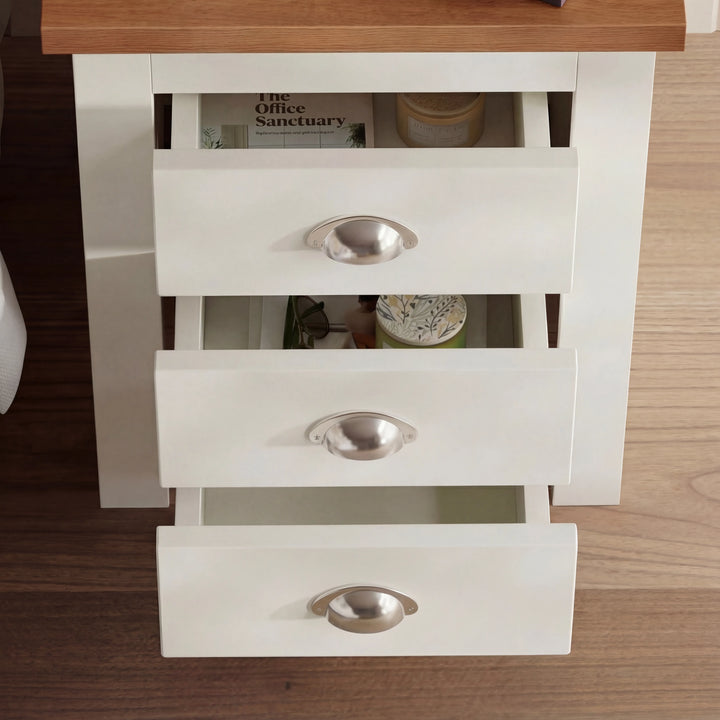 [White] Overhead angled view with all three drawers pulled open showing storage capacity and items inside