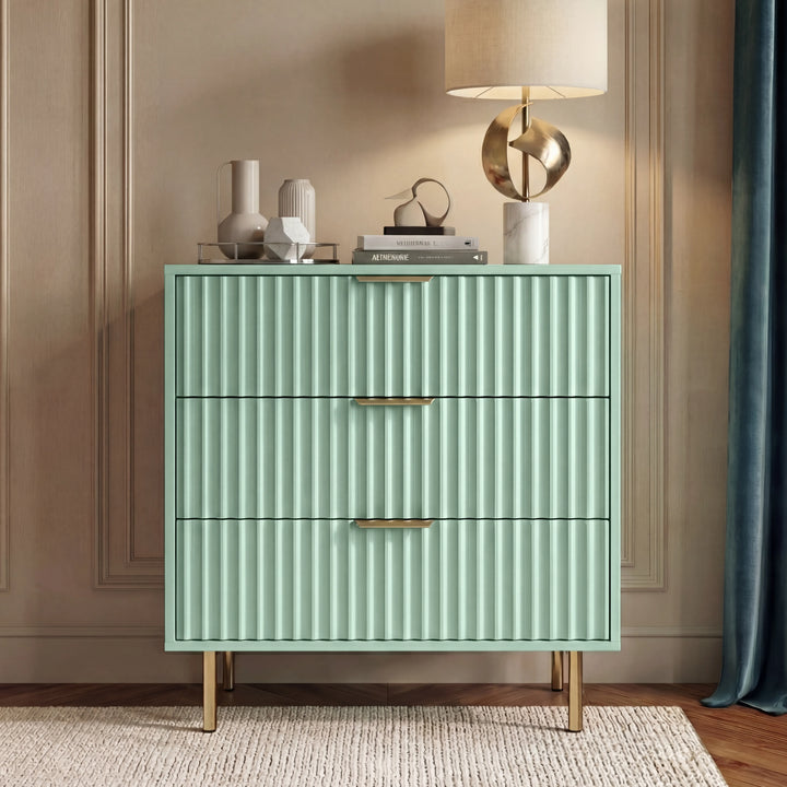 [Sage Green] flutrina 3 chest of drawers with gold handles and legs placed in a natural light room