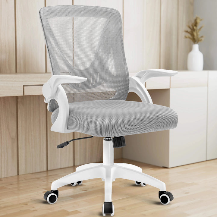 [White + Grey] The grey mesh chair in a home office provides ergonomic seating with a desk in the backdrop to enhance productivity.