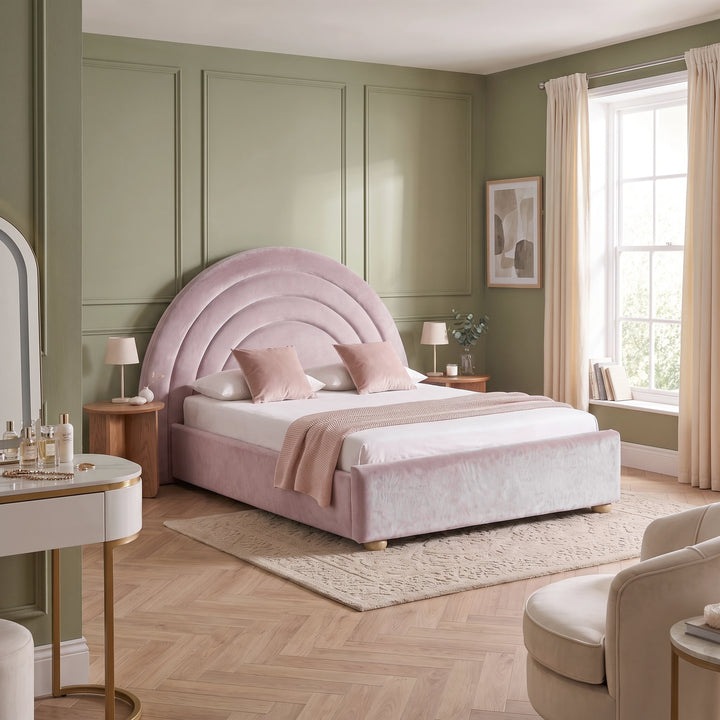 [Pink | Double] Wide bedroom view of pink rainbow ottoman bed with curved headboard, rug, side tables and window