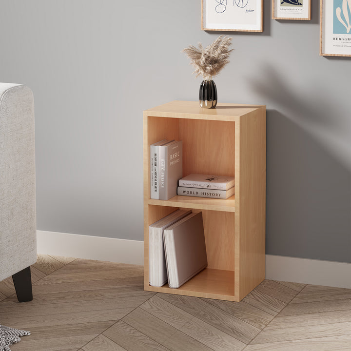 [2 Shelf | Beech] bedside-height pale beech bookcase tucked beside chair by warm taupe plaster wall