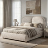 [Double | Beige] Embracea bed in an angled bedroom setting with lamp, rug, and abstract wall art in neutral tones