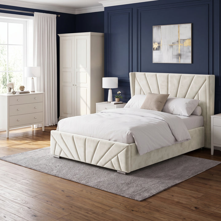 [Double | Beige] Full bedroom setting with the Sunrise Double Ottoman Storage Bed Frame Beige Velvet against a navy accent wall.
