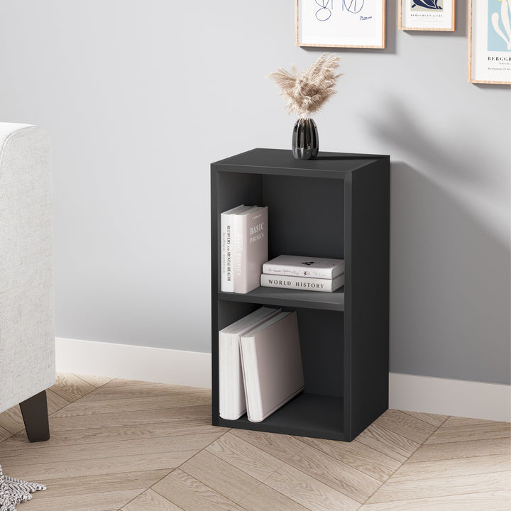 [2 Shelf | Black] bedside-height black-painted bookcase tucked beside chair by charcoal feature wall