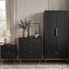 [Black] flutrina black 2 door wardrobe, 3 drawer chest and 2 drawer bedside grouped on brass legs against a panelled wall