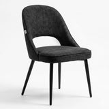[Black | Set of 4] Angled view of fabric dining chair with rounded open back, piped seat and four black legs.