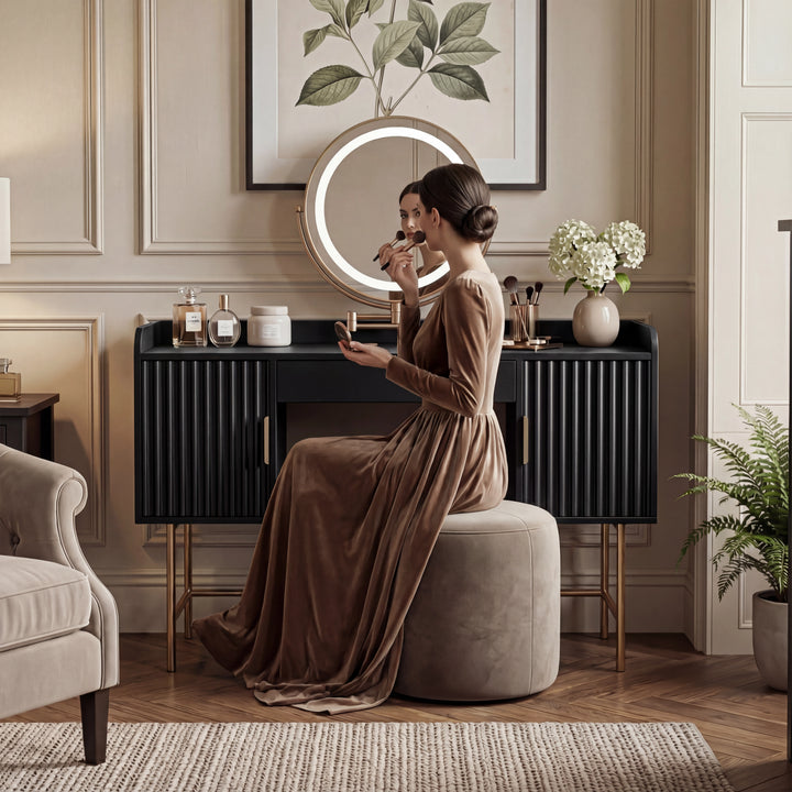 [Black] black flutrina dressing table with seated woman in brown dress applying makeup at the white-lit round LED mirror