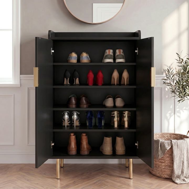[Black] Fluted Shoe Storage Cabinet with both doors open displaying five shelves of trainers, heels, loafers, and boots in a panelled hallway