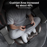 [Black] Person using a massage chair with increased cushion area, sitting cross-legged.
