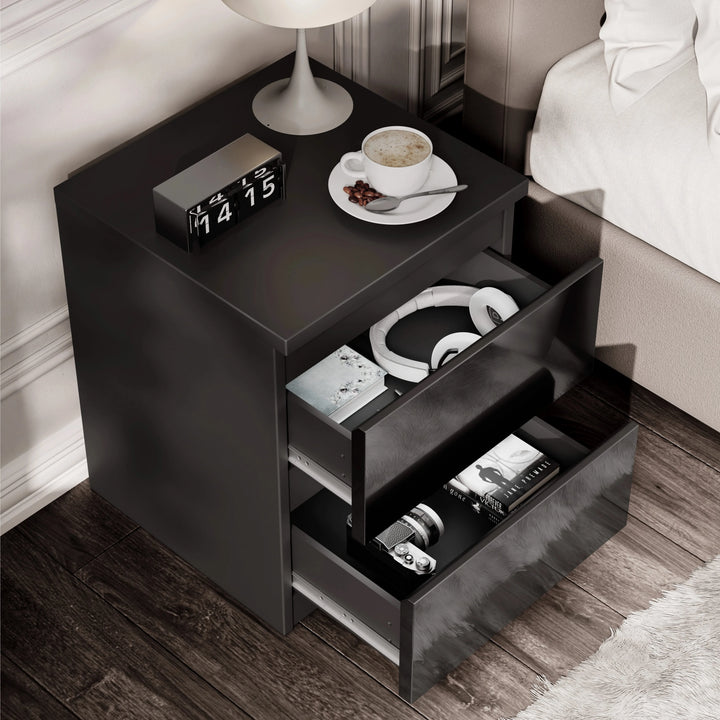 [Black] high gloss bedside table from above with both drawers open showing headphones and books