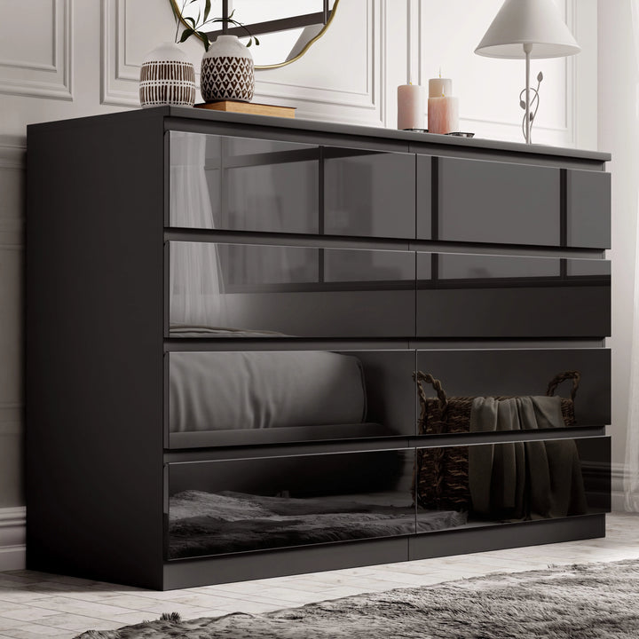 [Black] high gloss wide chest of drawers black shown in panelled bedroom with mirror and decor on top
