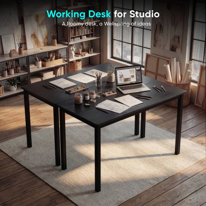 [100 X 50 cm] Black home office desk 100cm in art studio with sketches, laptop and brushes on top