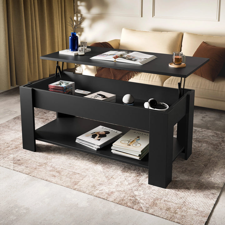 [Black] Lift top coffee table in black, top raised showing storage with magazines and headphones, beige sofa behind