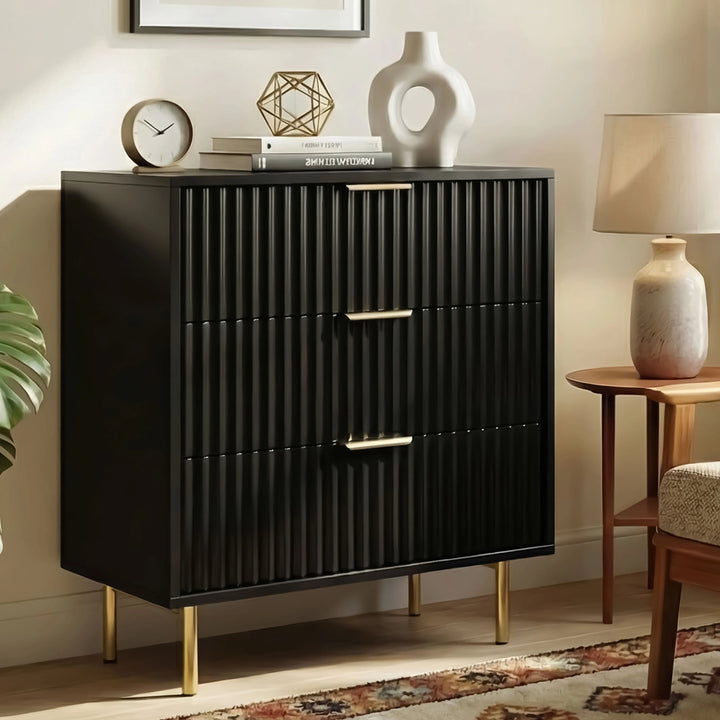 [Black] Front elevation of black bedroom drawers with three centred golden handles and flutrina design