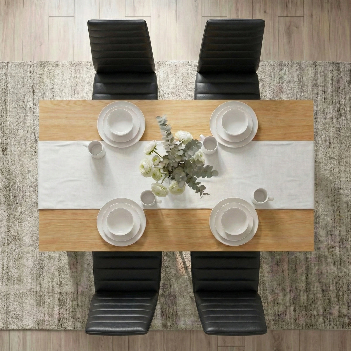 [4 Seater | Black] Dining Table and Chairs Set seen from directly above with four place settings, white table runner, glassware, and a floral centrepiece