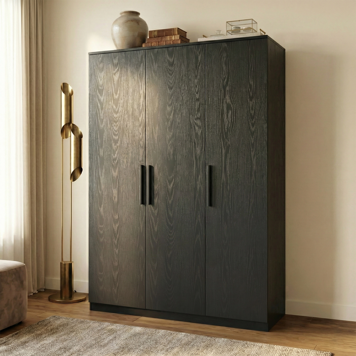 [Black] Three quarter view Blythe wardrobe against pale wall showing front and side panels