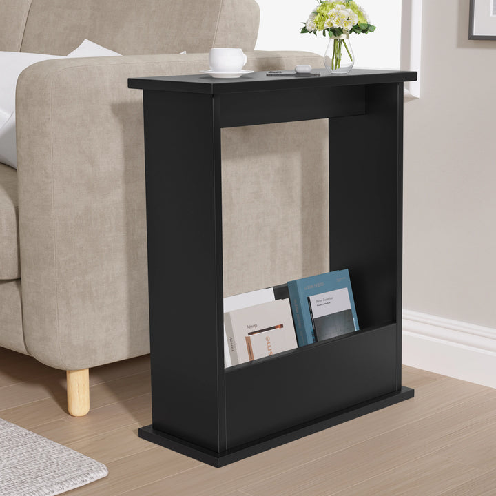 [Black] side table with books and a vase in a living room setting