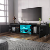 [Black] Angled view of black gloss TV unit, window left, TV mounted on grey wall, blue LED shelves