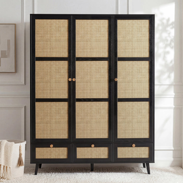 [Black] Black rattan wardrobe shown front-facing beside a wicker basket and framed wall art in a panelled room
