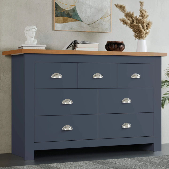 [Blue] Shaker 7 drawer wide chest front view with oak top and pampas grass in vase on top.