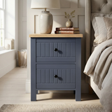 [Blue] Two drawer Linra bedroom furniture set bedside on tapered legs with oak top supporting ceramic lamp