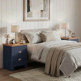 [Blue] Neatly arranged bedroom with a bed, nightstands, and decor items.