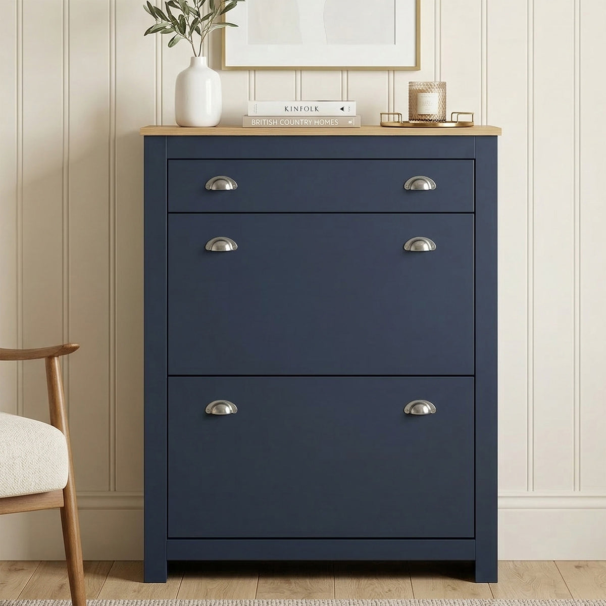 [Blue] Shoe Cabinet With Drawer front view in a styled hallway with oak top, silver cup handles, and a vase and books