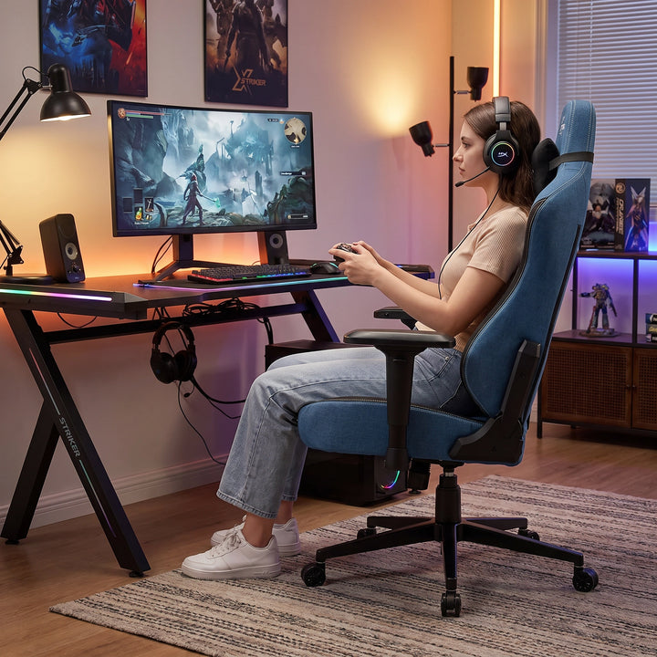 [Blue] Xstriker gaming chair built with premium materials with a woman sitting and enjoy playing games with headphones on.