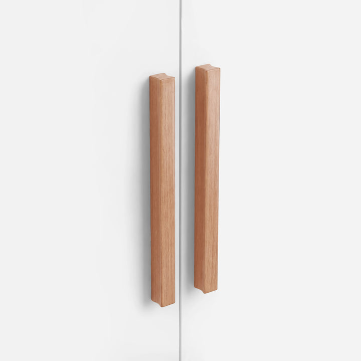 [White] Close view of two vertical light wood handles mounted on white Blythe wardrobe doors