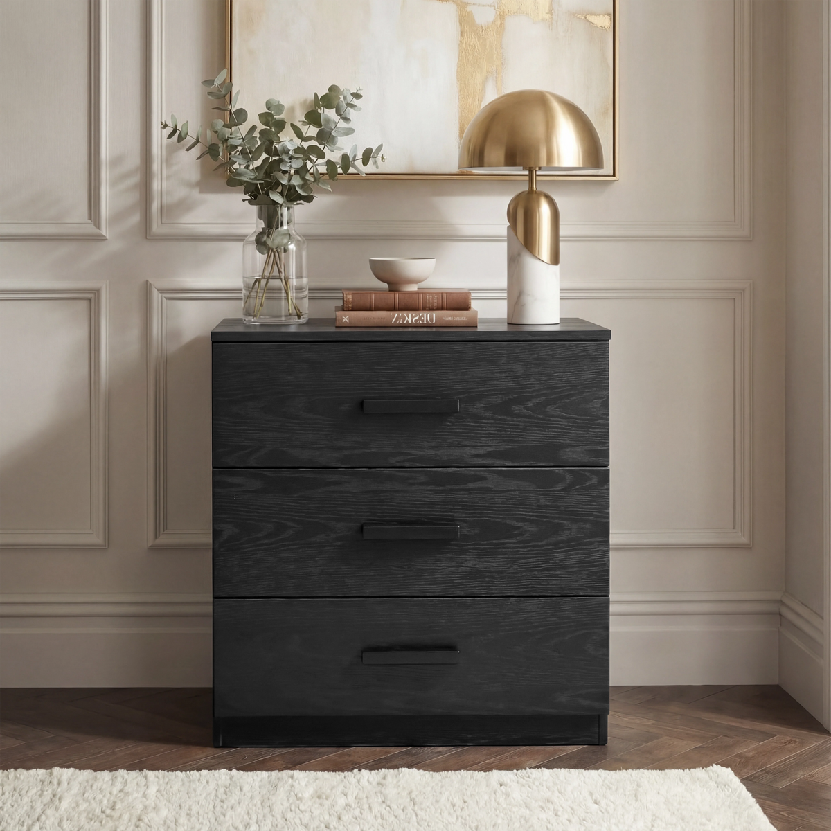 [Black] Blythe bedroom furniture set 3 drawer chest shown head on against a cream panelled wall