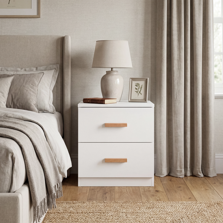 [White] Blythe bedroom furniture set 2 drawer bedside placed between a bed and a curtained window