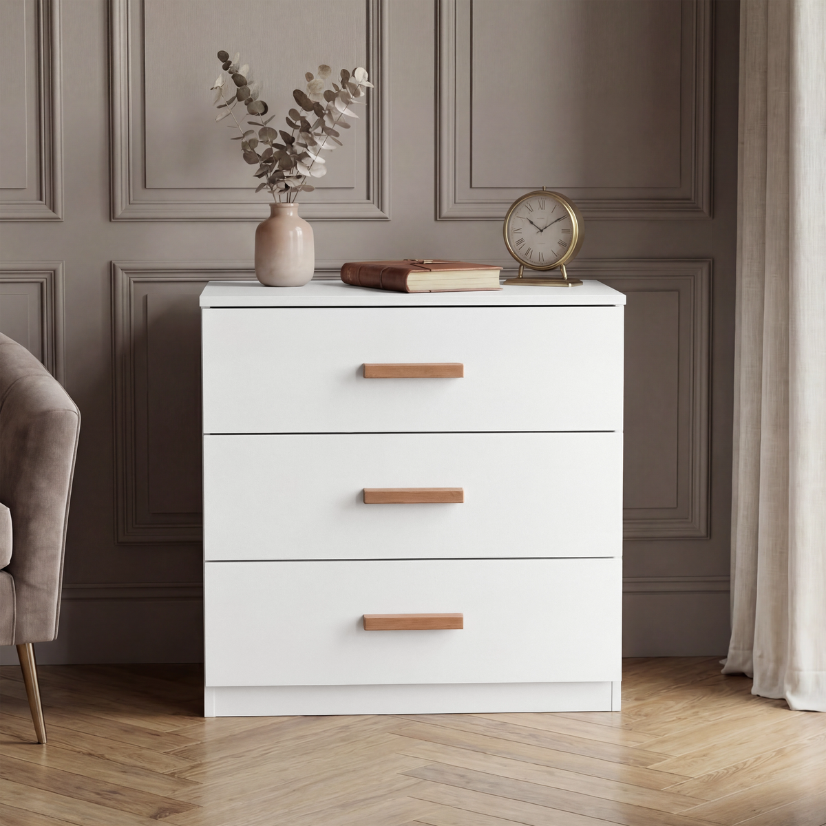 [White] Chest piece of the Blythe bedroom furniture set shown on a herringbone floor with a panelled wall behind it