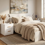 [White] Neatly made bed with beige bedding in a well-lit bedroom.