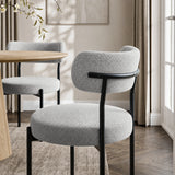 [Light Grey | Set of 4] Rear lifestyle view of boucle dining chair with curved backrest and black metal frame.