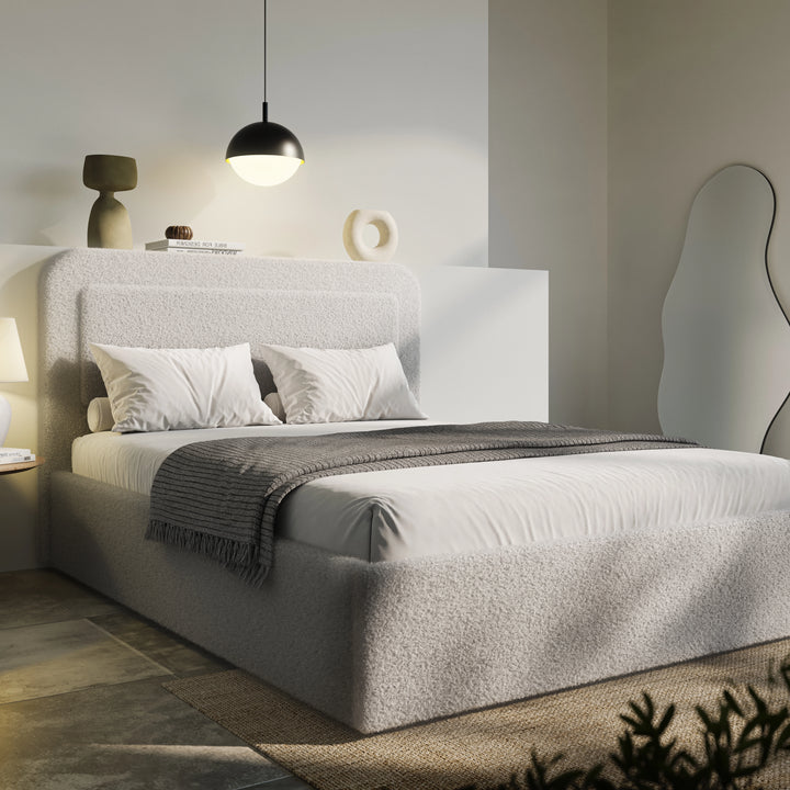[Double | Grey] Grey boucle double ottoman bed angled, charcoal tasselled throw draped over foot of low storage base