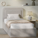 [Single | Grey] Grey boucle single ottoman bed angled, soft greige pill headboard and gas-lift base with beige throw