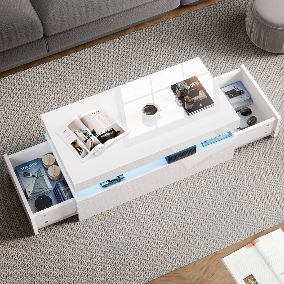 [White] Overhead view of white storage coffee table with both side drawers extended showing books and magazines inside