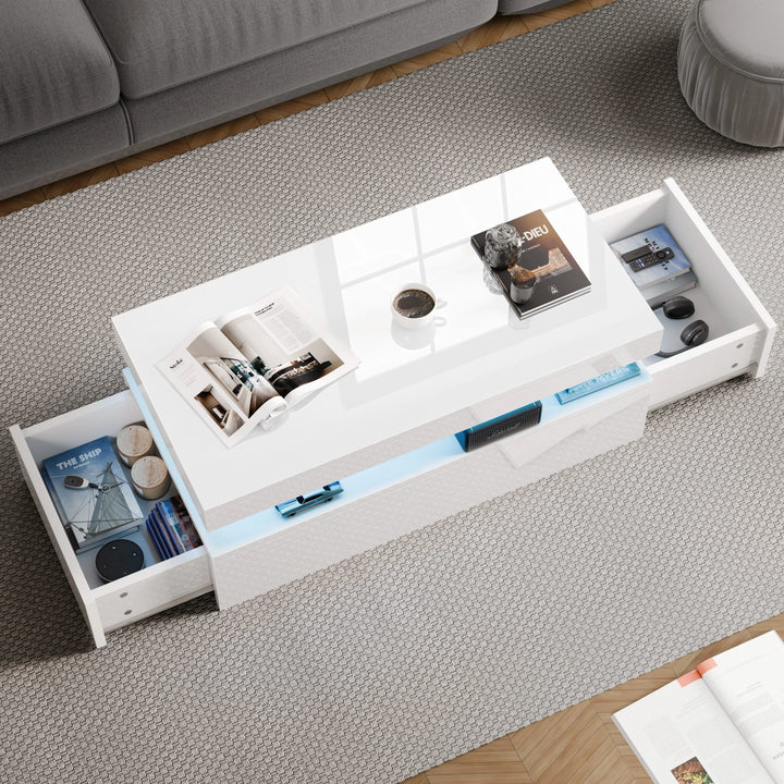 [White] Overhead view of white storage coffee table with both side drawers extended showing books and magazines inside