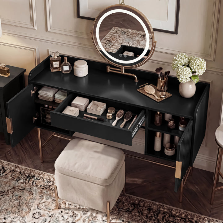 [Black] overhead shot of the black dressing table interior showing organised makeup, brushes and a vase of flowers