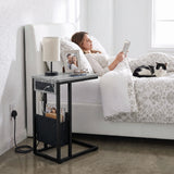 [Concrete] side table beside bed with concrete-effect top, charging station, lamp, phone and storage pouch