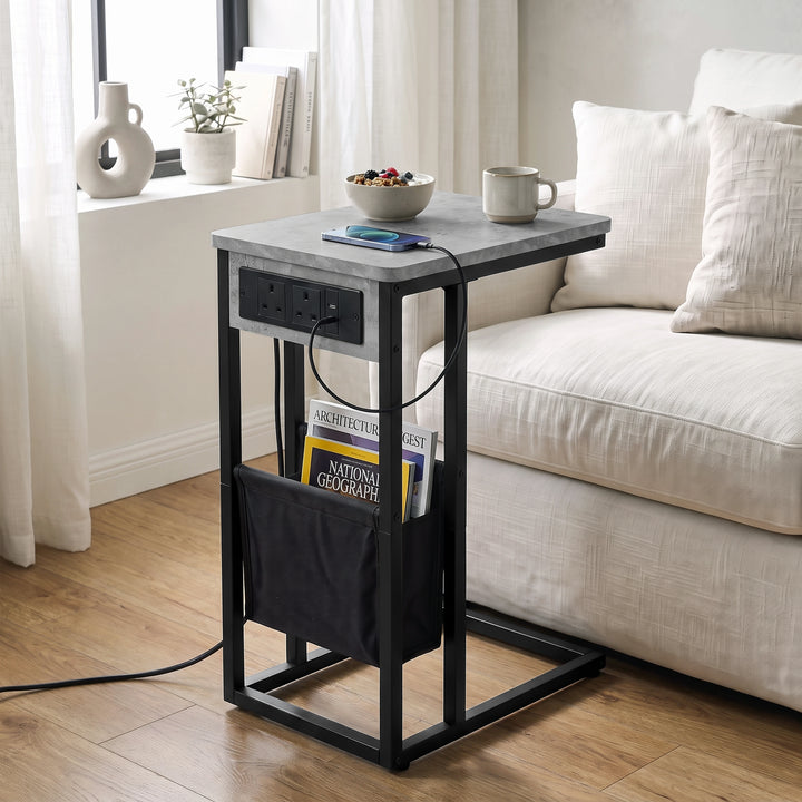 [Concrete] C-shaped side table by sofa with concrete-effect top, socket panel, black pouch and sofa base