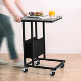 [Concrete] movable side table being rolled on caster wheels with snacks and drink on tabletop
