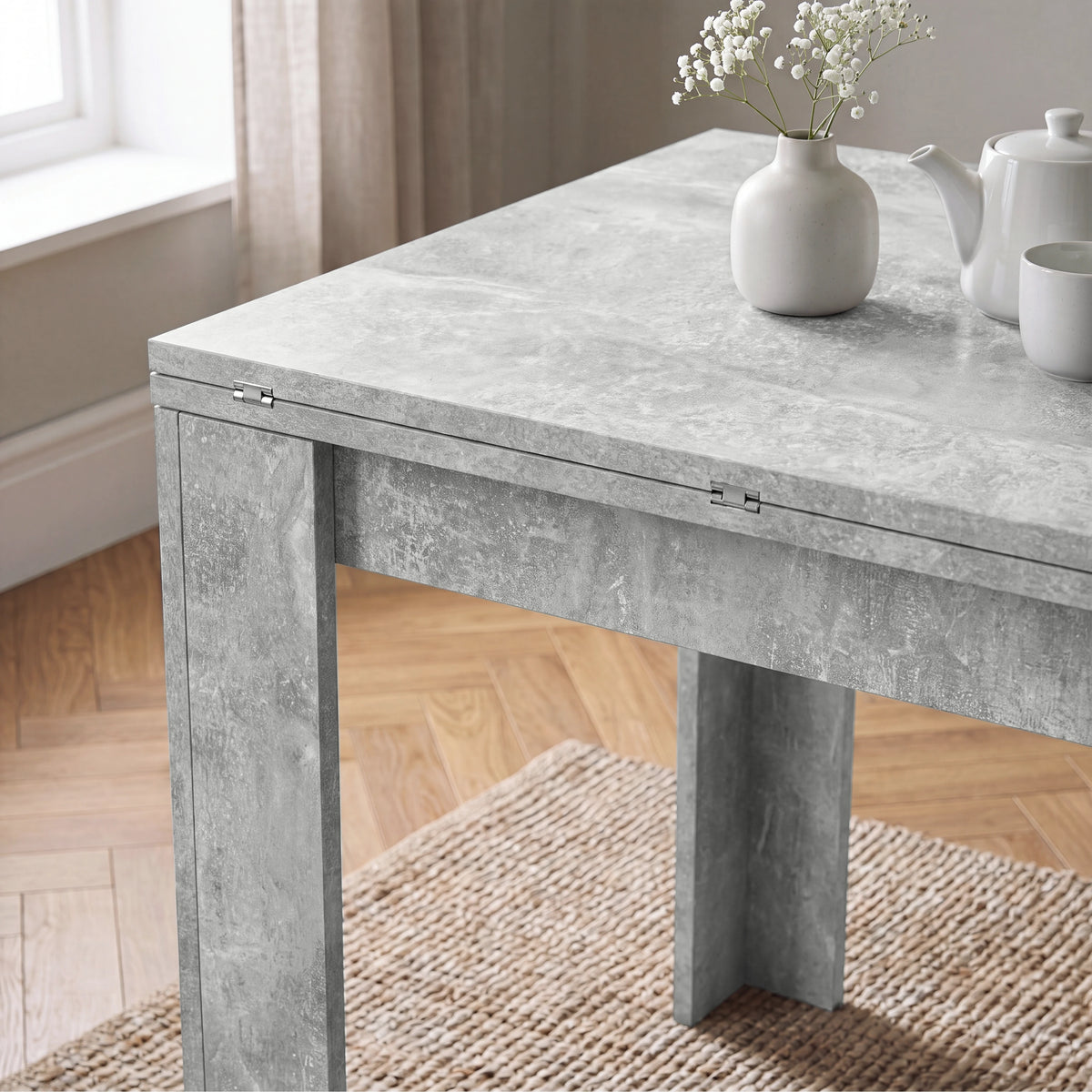 [Concrete] Close-up of the folded tabletop showing the surface finish, steel hinges and wide supporting legs