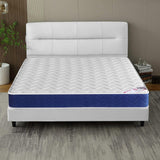 [White | Small Double] Sprung mattress room view, white panelled headboard, fabric divan base and corner wall lamp.