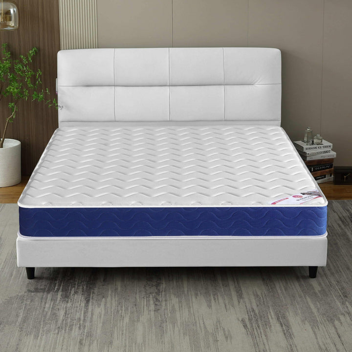 [White | Small Double] Sprung mattress room view, white panelled headboard, fabric divan base and corner wall lamp.